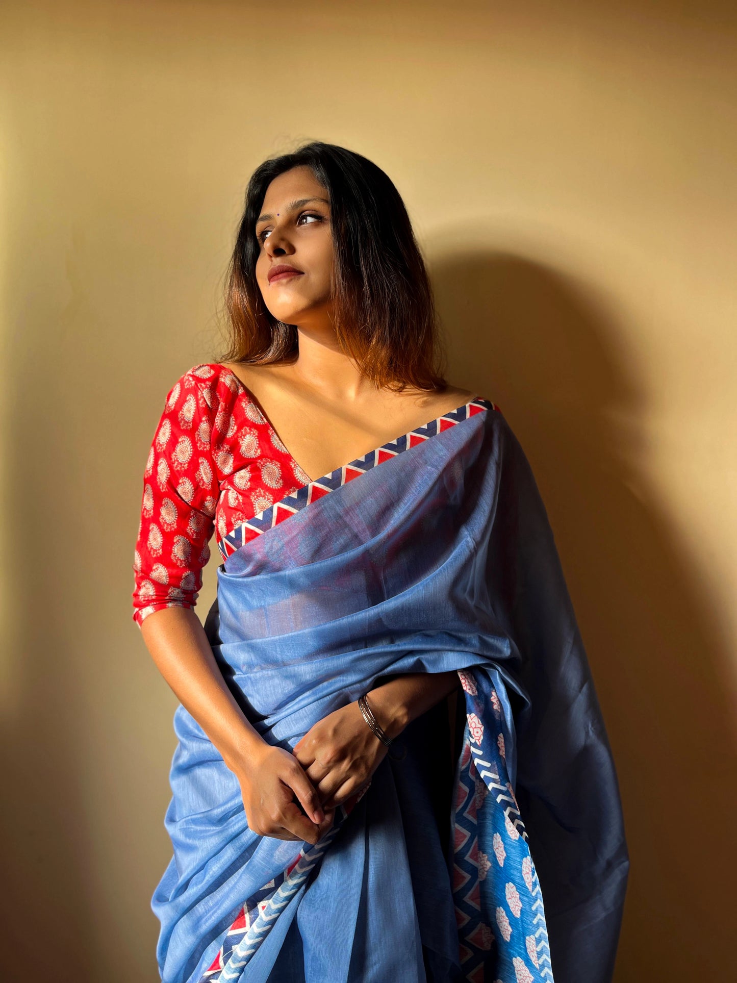 Blue Saree Paired With Red Printed Blouse