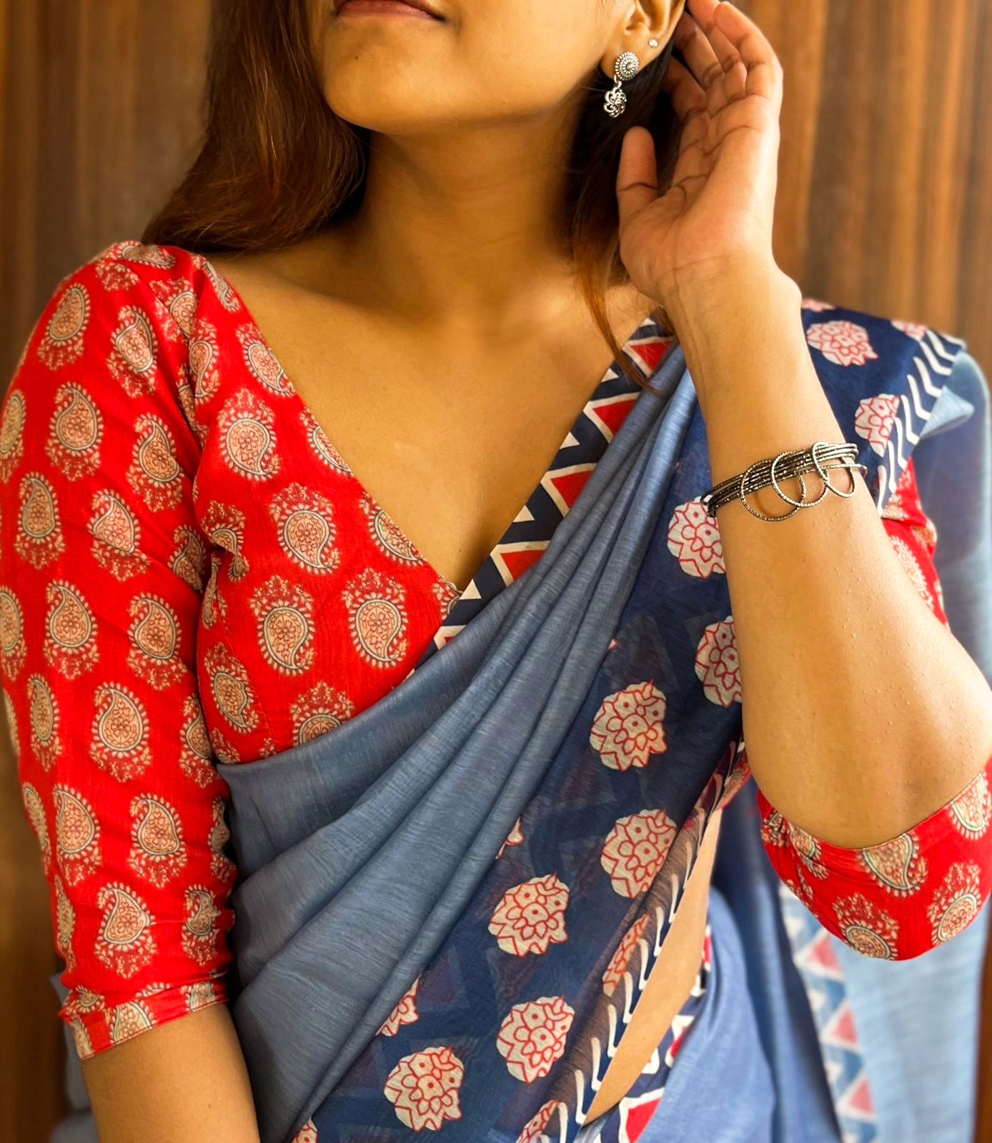 Blue Saree Paired With Red Printed Blouse