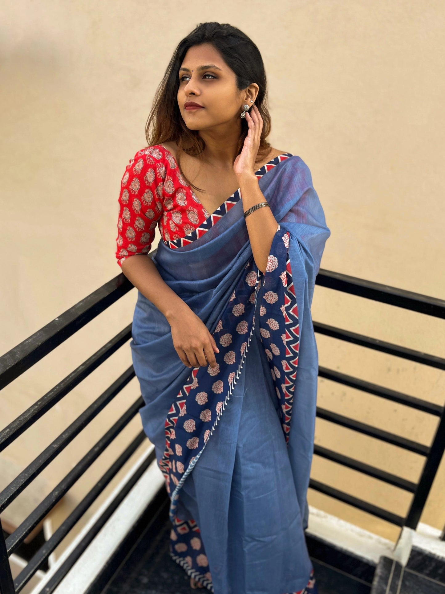 Blue Saree Paired With Red Printed Blouse